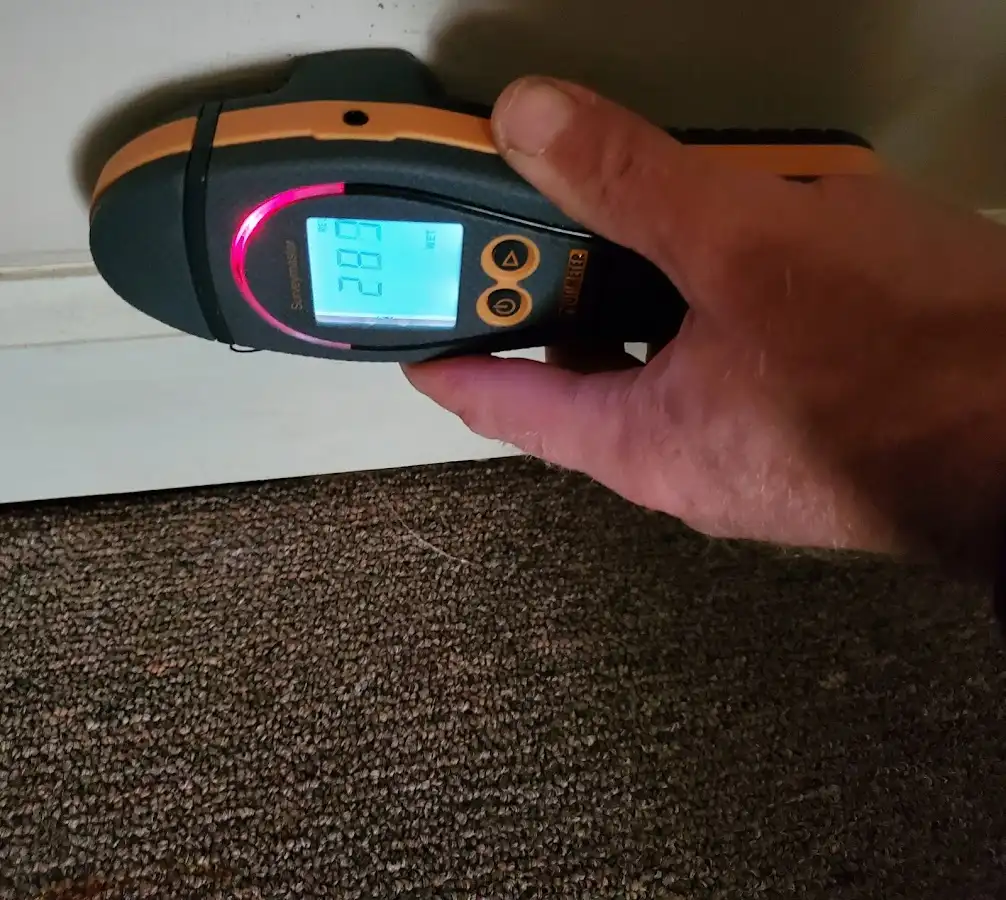 Moisture detection at baseboard during Storm Damage Restoration in Rockford
